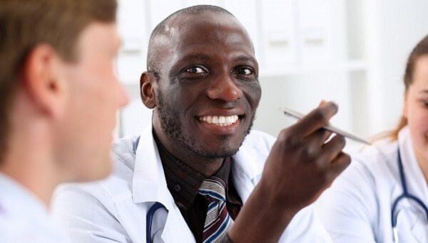 a male physician smiling in a classroom